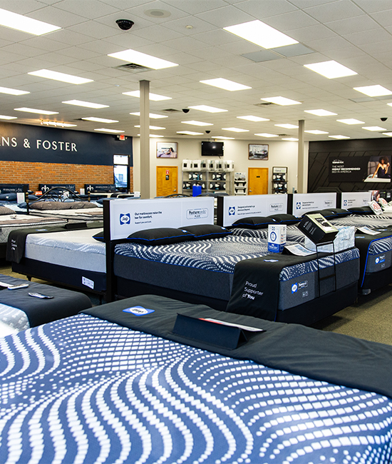 open showroom with several dozen beds on display at The Sleep Center